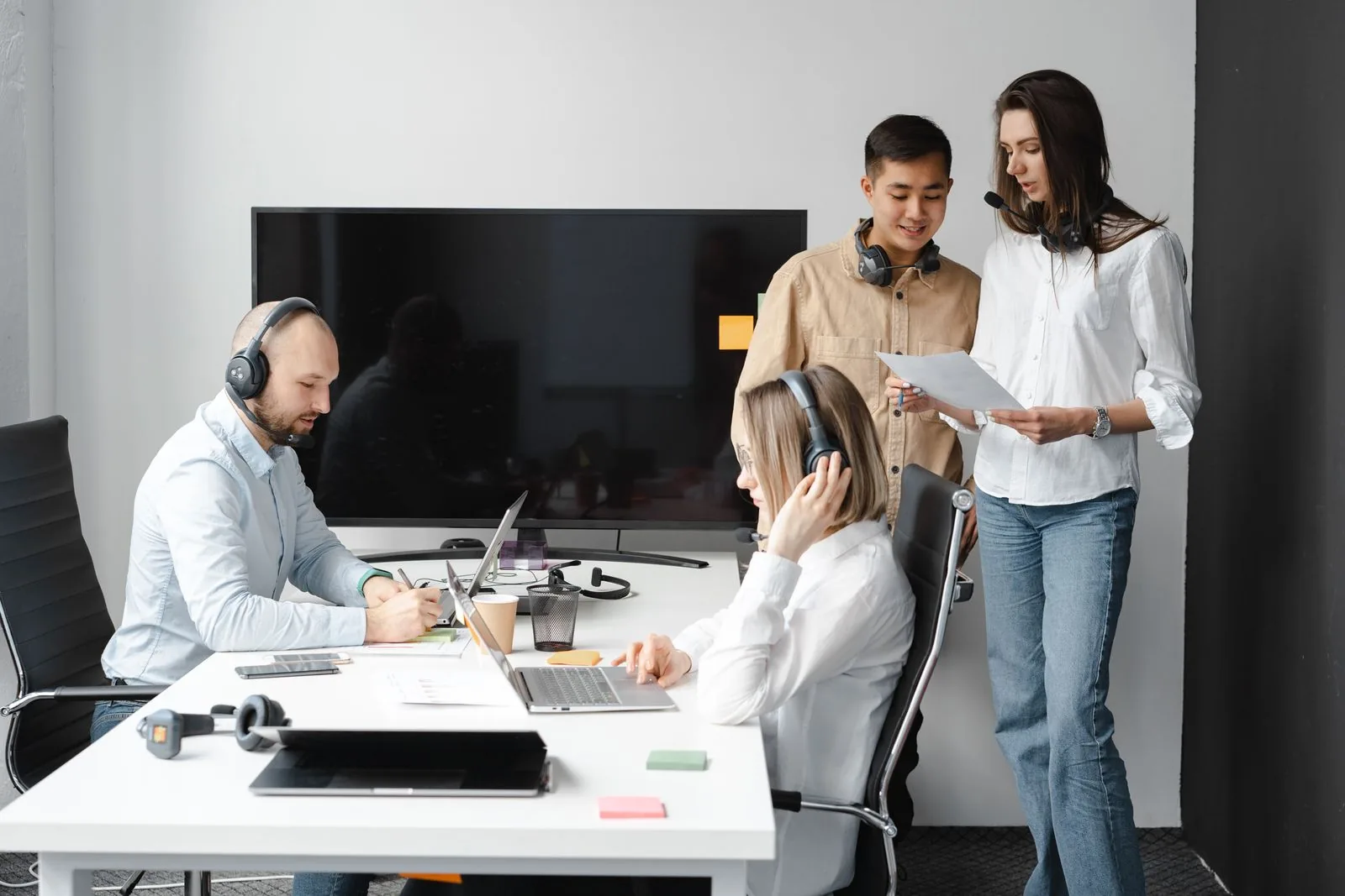 A team wearing headsets working together in an office