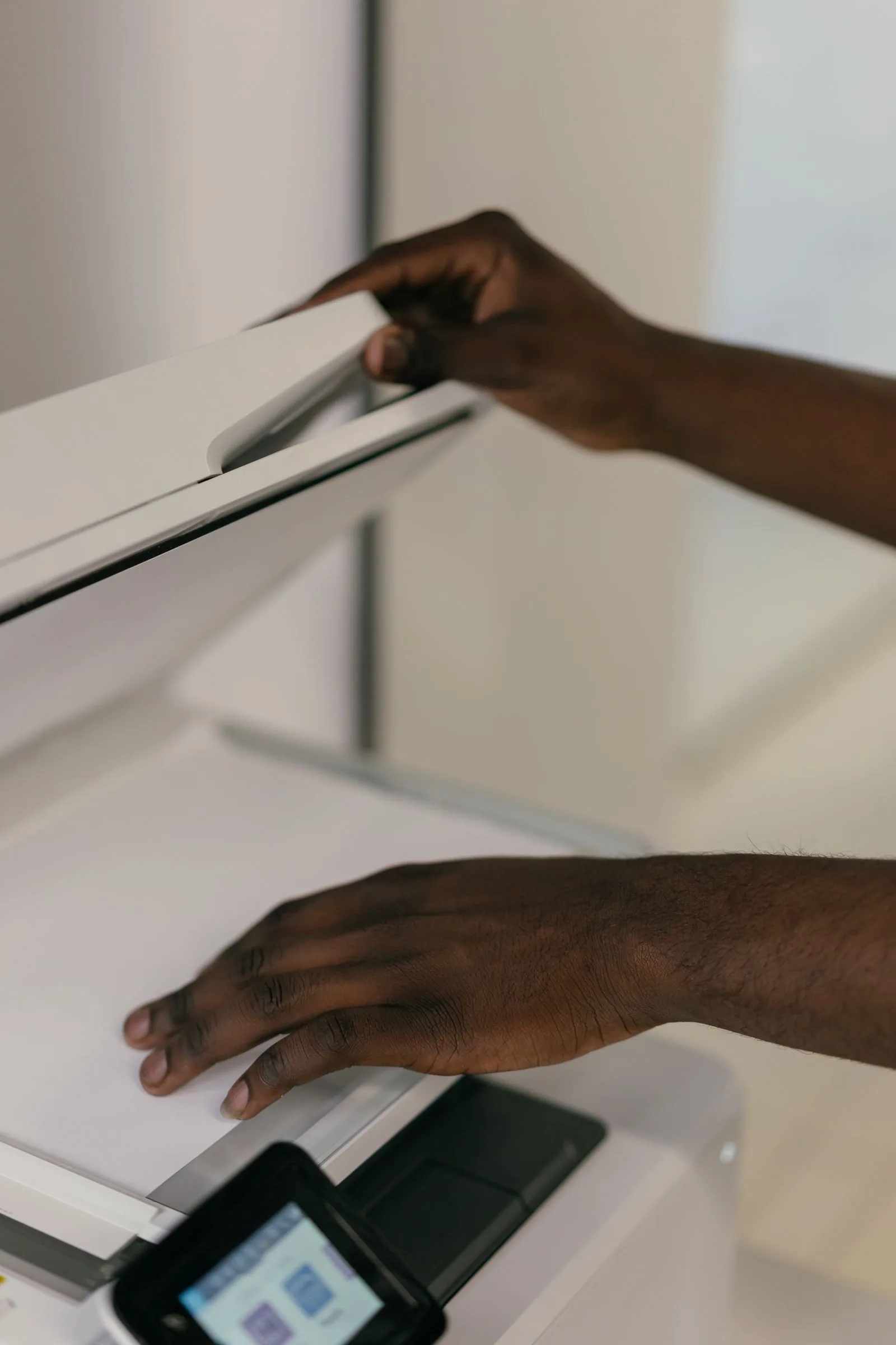 Hands placing a document into a scanner