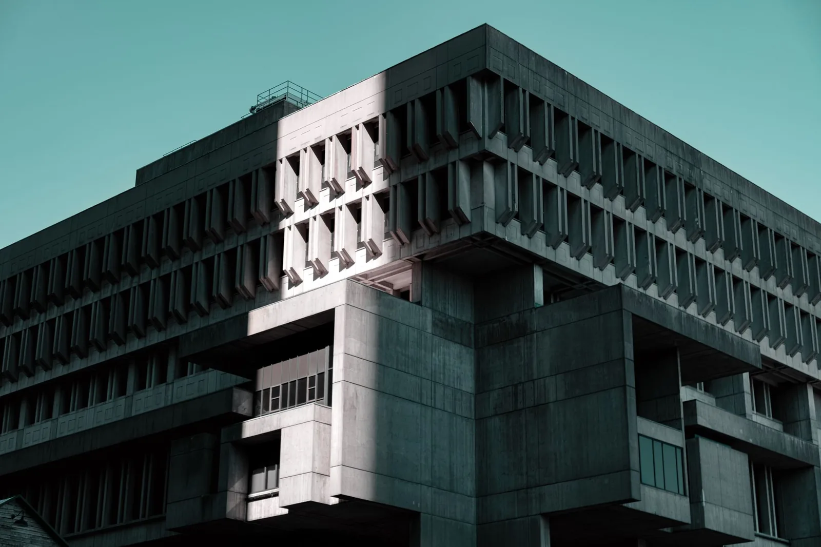 A modern civic government building seen from below