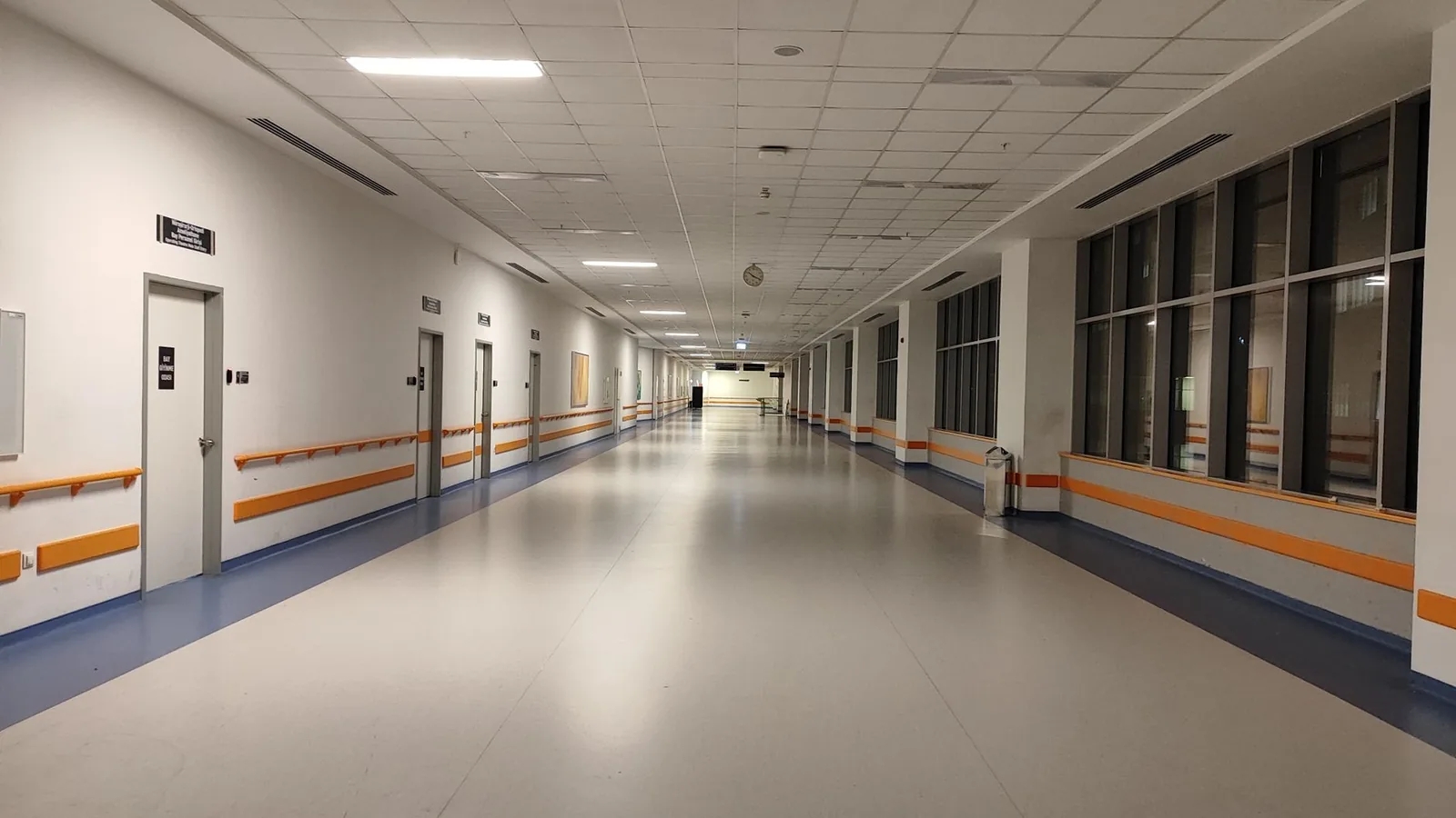 A clean, empty corridor inside a modern hospital