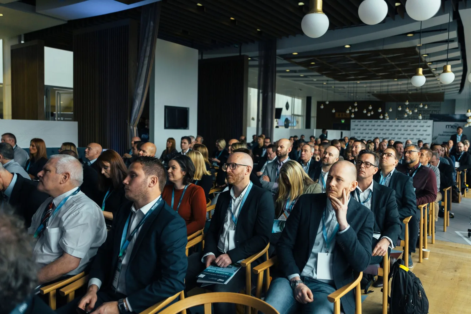 An audience seated at a business conference presentation