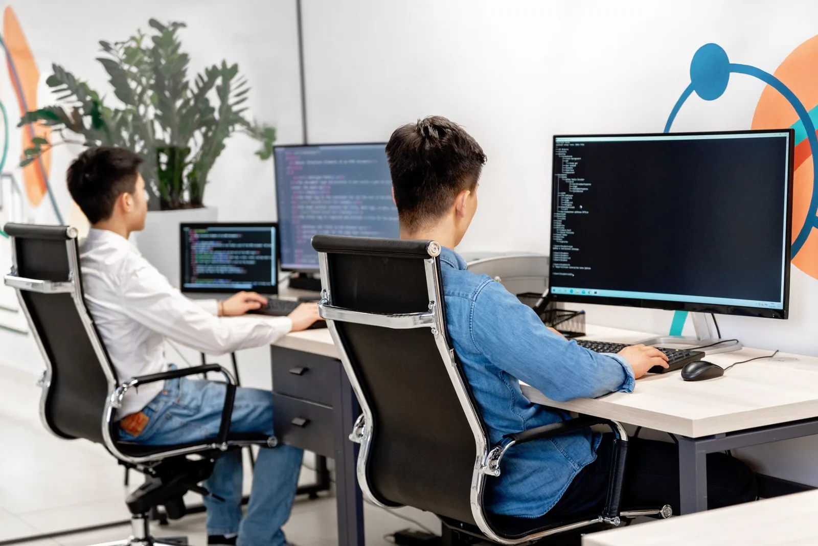 Software engineers working at desks in an open-plan office